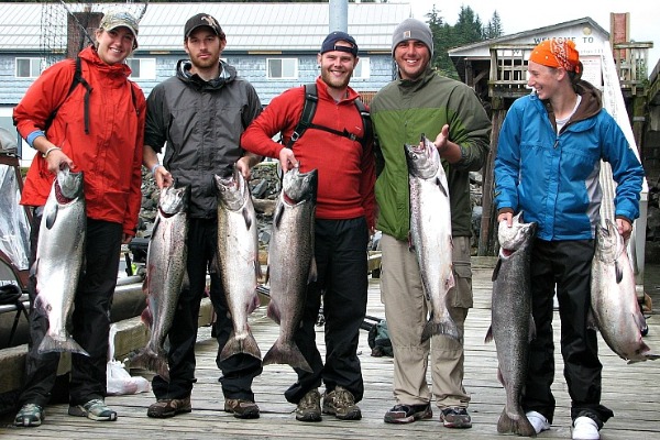 Happy customers pose with caught fish