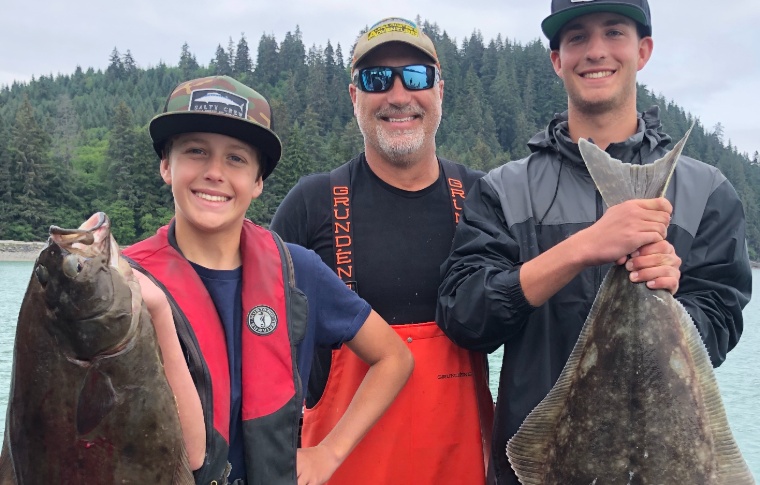 Happy youngsters pose with halibut and guide